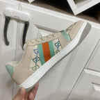 Gucci unisex sneakers, cream with orange-teal stripe and blue embroidery detail