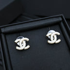 Chanel CC stud earrings with white enamel and gold-tone metal frames