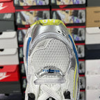 Shoe heel in silver-white mesh with blue paneling and neon green edging, lace-up