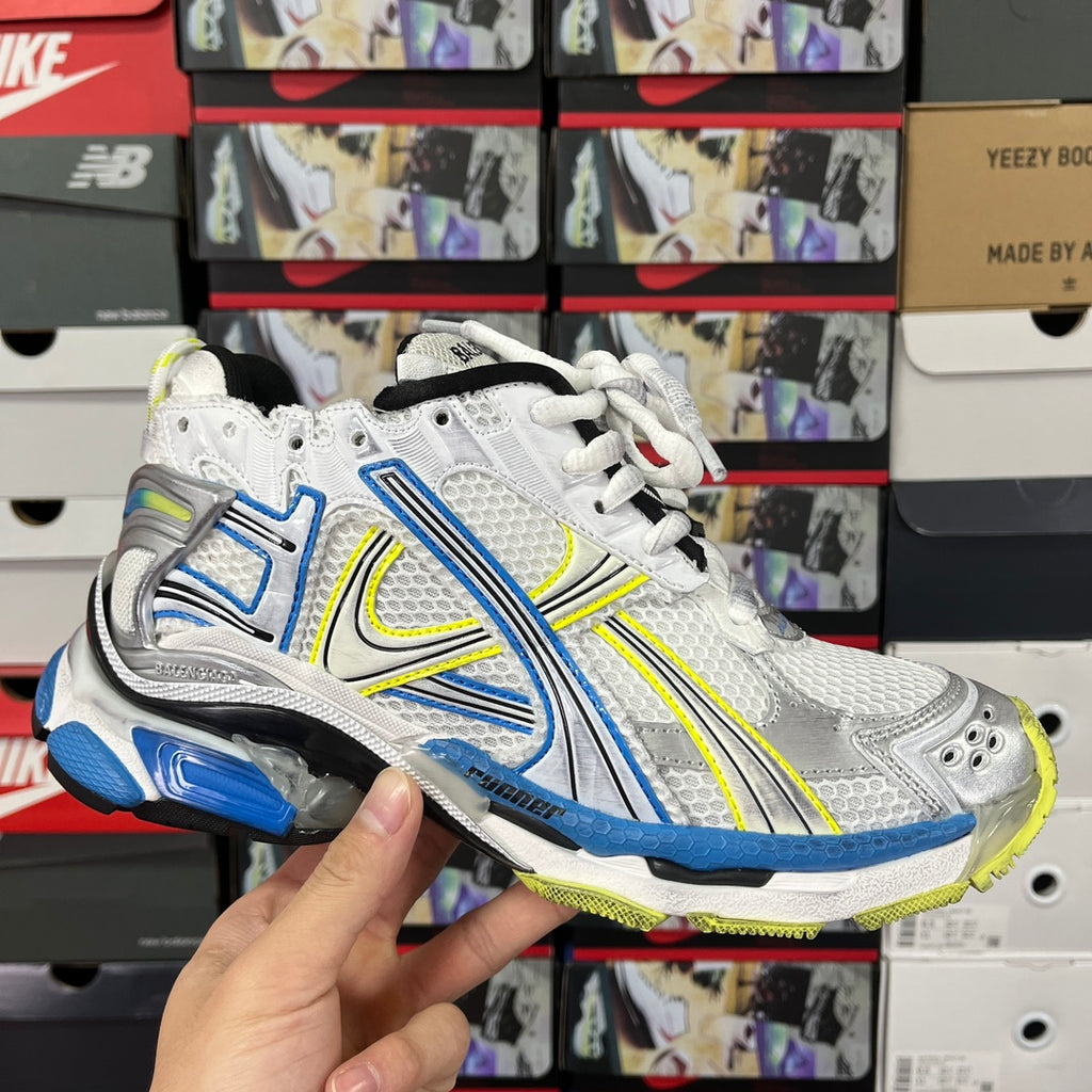 Unisex athletic shoes in white with blue and neon green accents, black sole, mesh upper