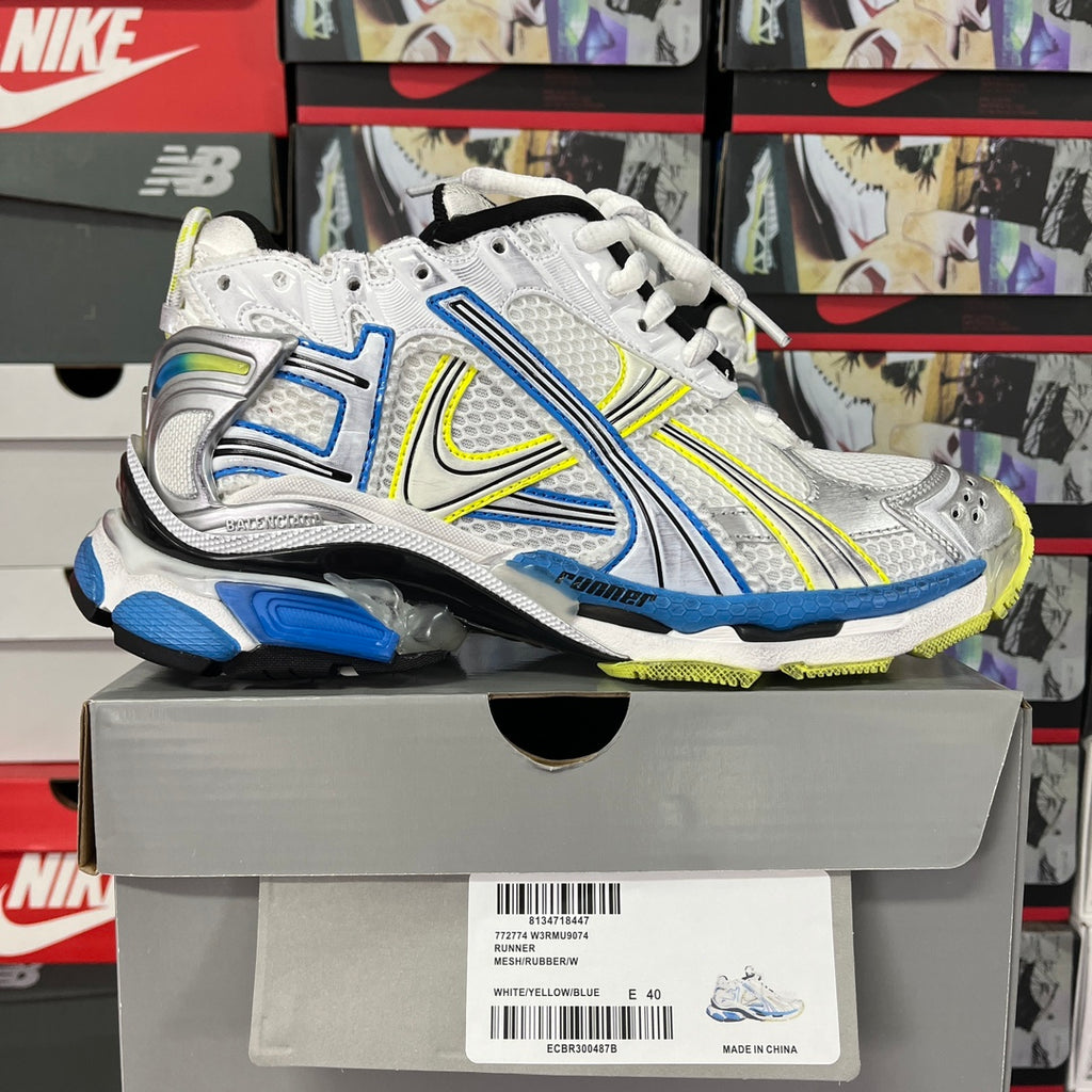 Unisex athletic shoes, white with blue and neon green trim, lace-up, on box