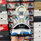 Unisex athletic shoes from the back, white upper with blue accents and neon green details