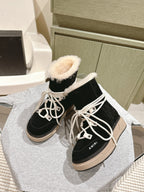 Black high-top lace-up boots with faux-fur trim and beige platform sole.