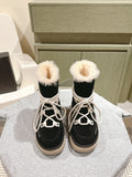 Black high-top boots with white laces and faux-fur cuffs, beige rubber soles.