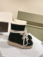 Black high-top boots with white laces, faux-fur cuff and beige lug sole.
