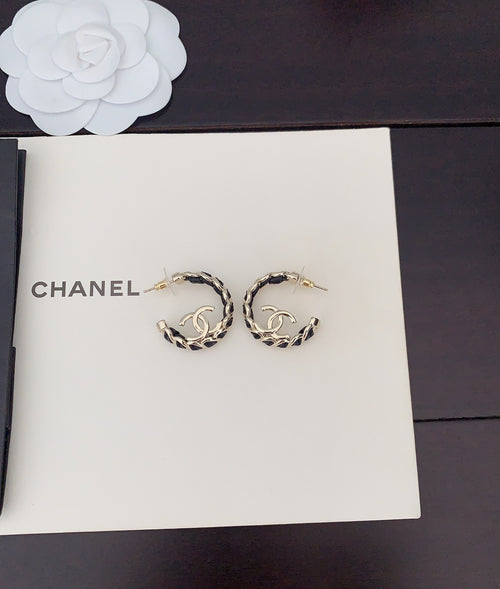Gold-tone chain hoop earrings with CC logo, laid on card