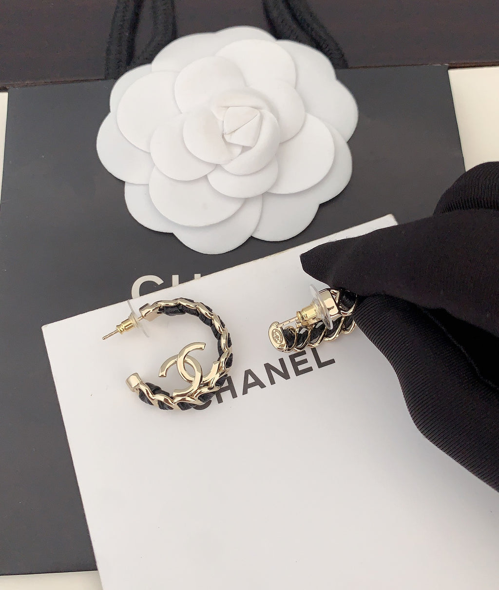 Gold-tone chain hoop earrings with CC logo, close-up on card