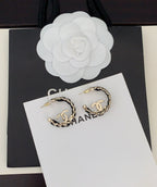 Gold-tone chain hoop earrings with CC logo, front view on card