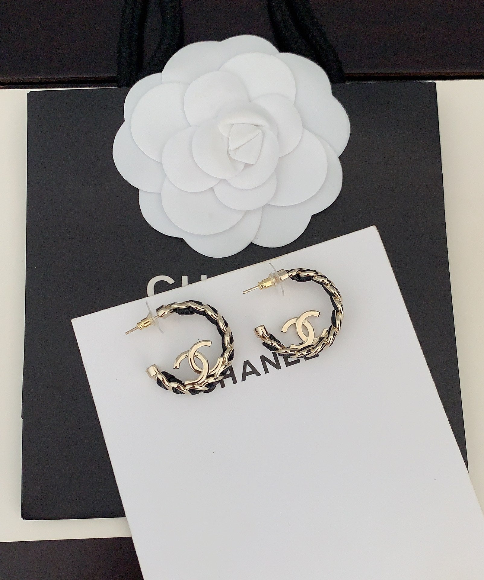 Gold-tone chain hoop earrings with CC logo, front view on card