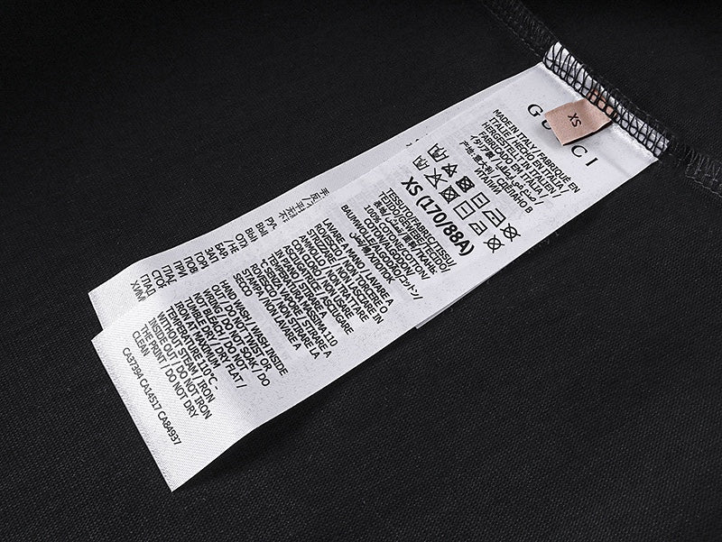 Black T-shirt interior with white care label tag at the neck