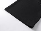 Black T-shirt hem close-up with stitched fabric edge