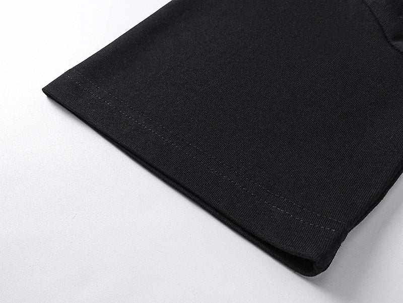 Black T-shirt hem close-up with stitched fabric edge