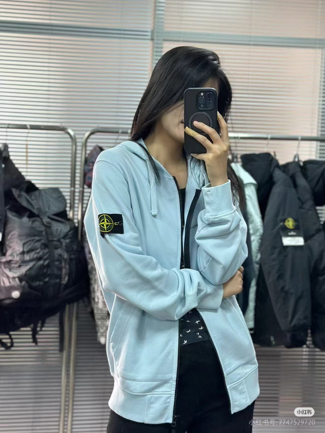 Light blue Stone Island zip-up hoodie, side view with sleeve logo patch and black zipper