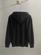 Black hoodie back view with hood and long sleeves.