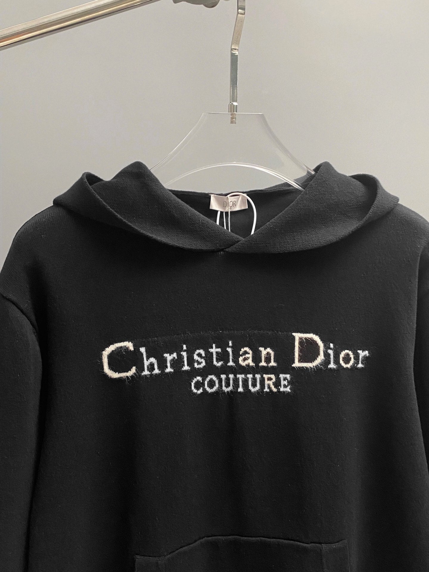 Black hoodie chest logo: Christian Dior Couture text embroidery.