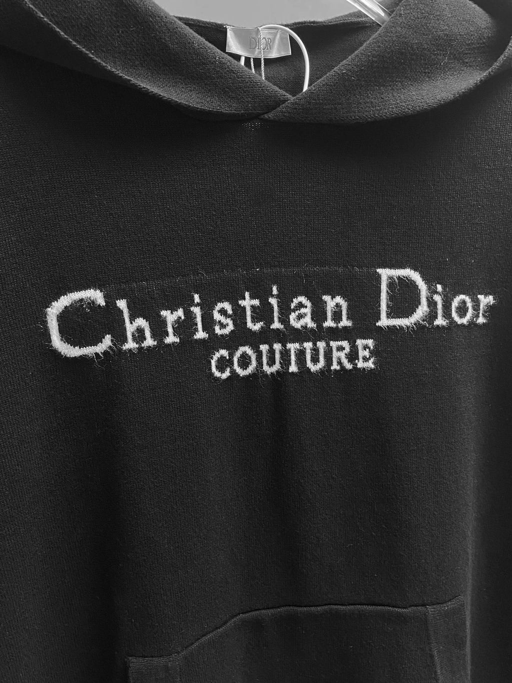 Black hoodie with large 'Christian Dior' Couture logo embroidery.