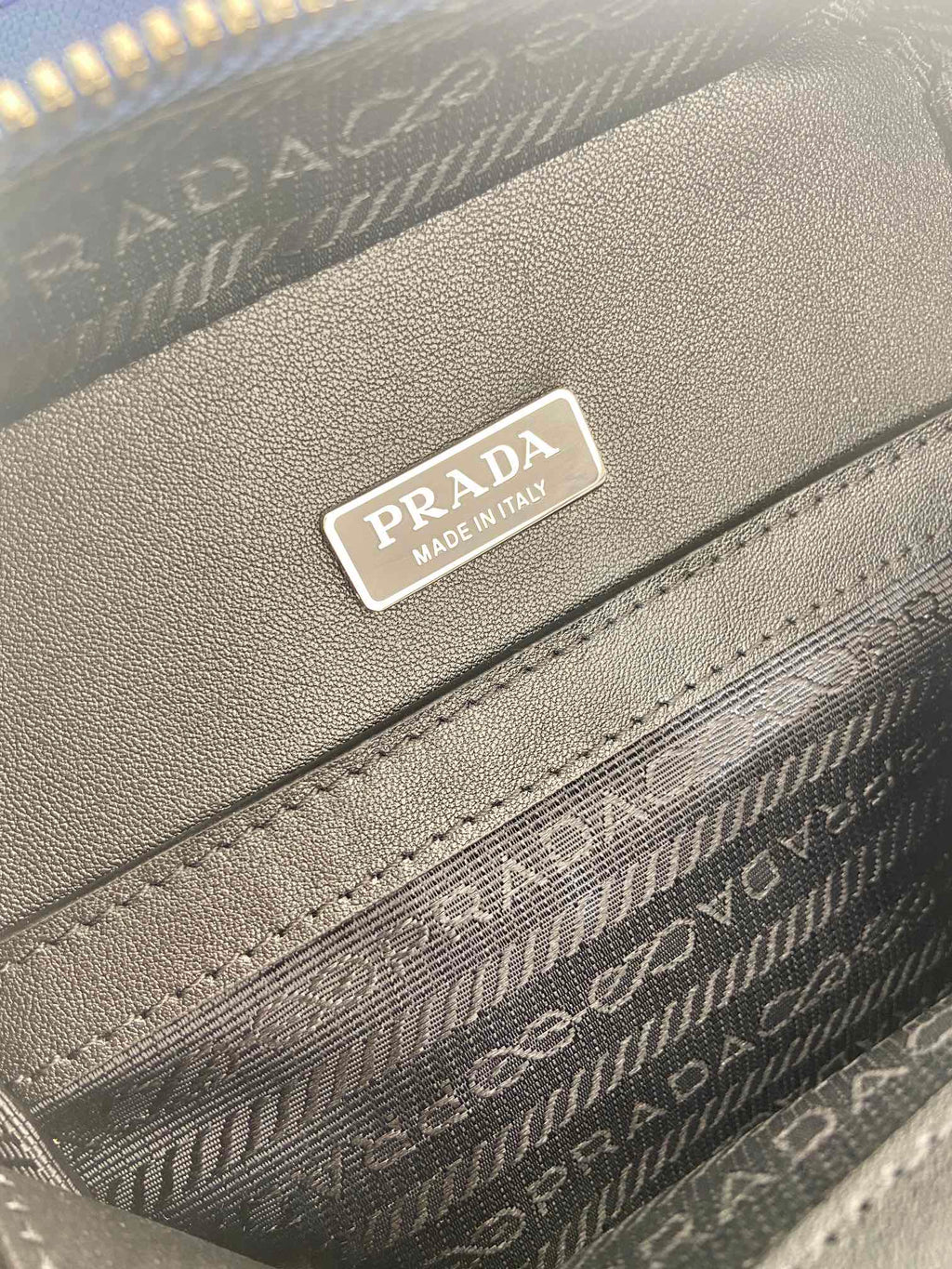 Gray interior label reading Prada and Made in Italy on patterned lining
