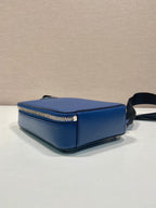 Blue mini crossbody bag side view with gold-tone zipper and black strap