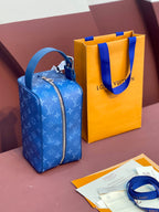 Louis Vuitton blue monogram bag with zipper front and matching leather handles