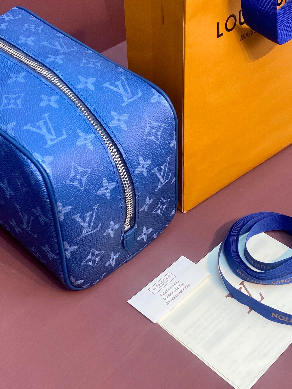Louis Vuitton blue monogram mini bag with curved front zipper and top edge