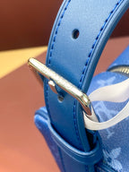 Louis Vuitton blue leather strap end with gold-toned hardware and snap loop