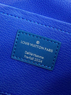 Louis Vuitton blue leather luggage tag with “Louis Vuitton Paris” text