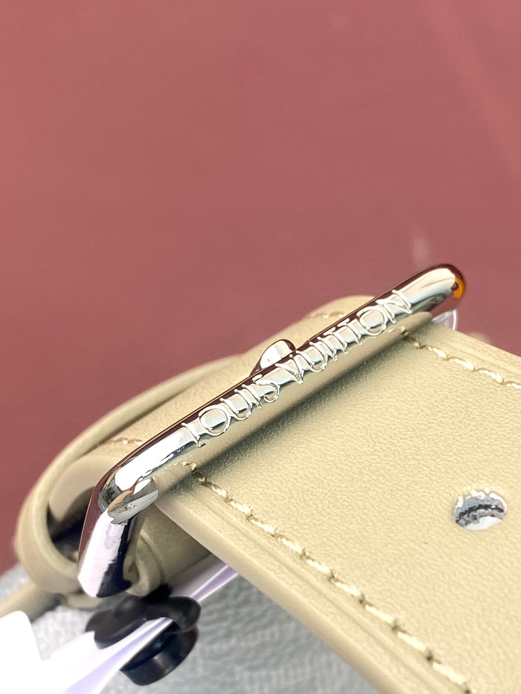 Louis Vuitton monogram bag zipper pull and stitching on light blue exterior