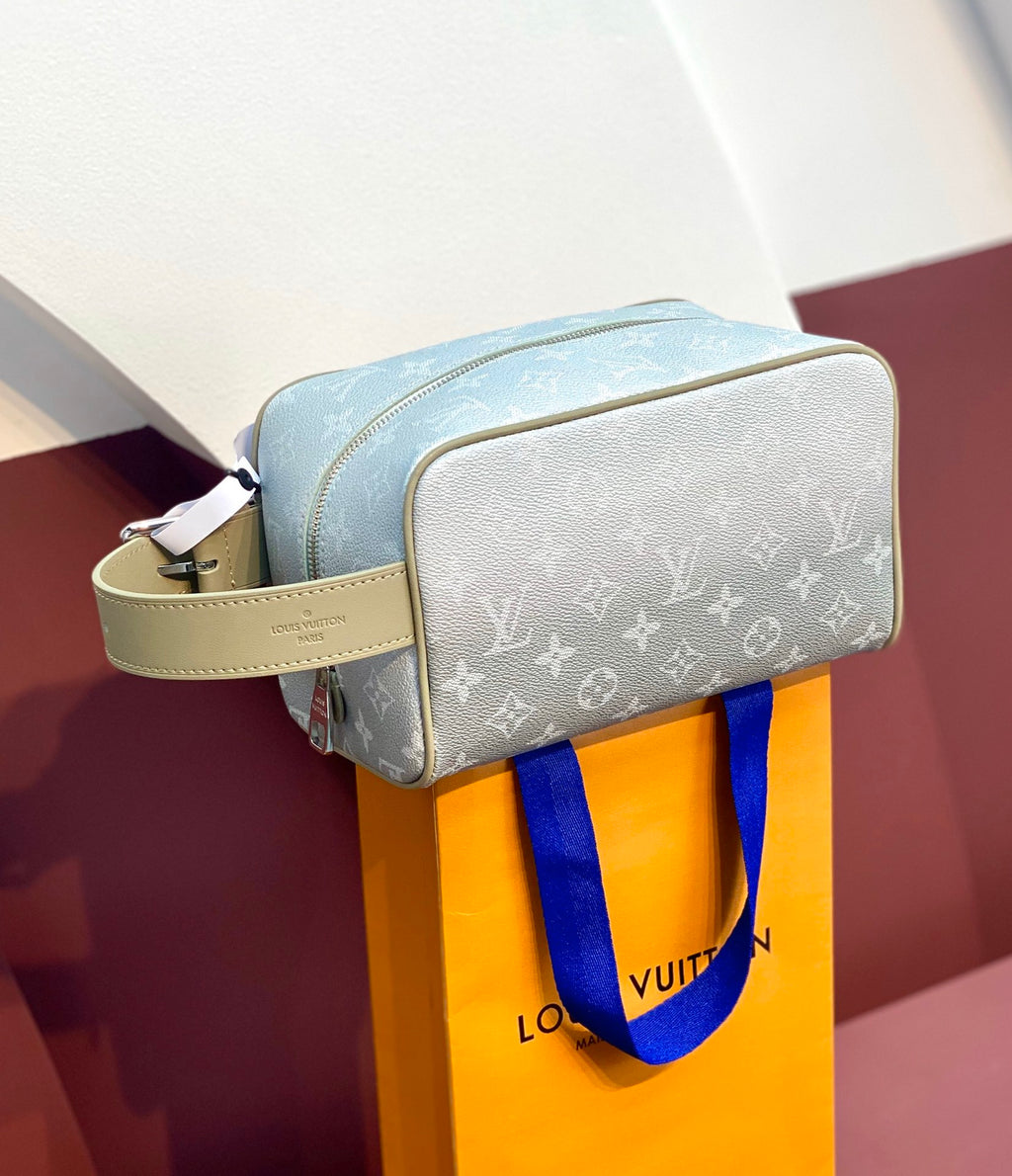 Louis Vuitton monogram toiletry bag with top zipper and wrist strap, light blue