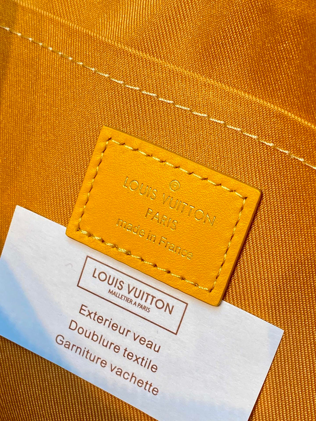 Leather label on tan monogram handbag: Louis Vuitton Paris made in France