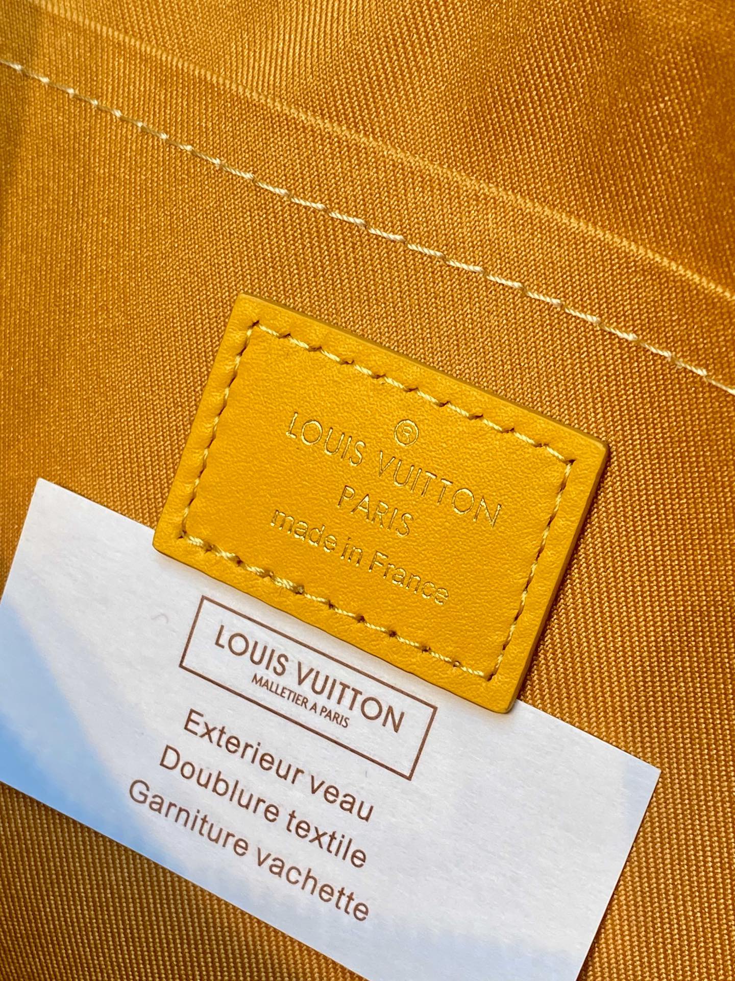 Leather label on tan monogram handbag: Louis Vuitton Paris made in France