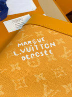 Tan monogram handbag close-up with engraved-style text and logo on front