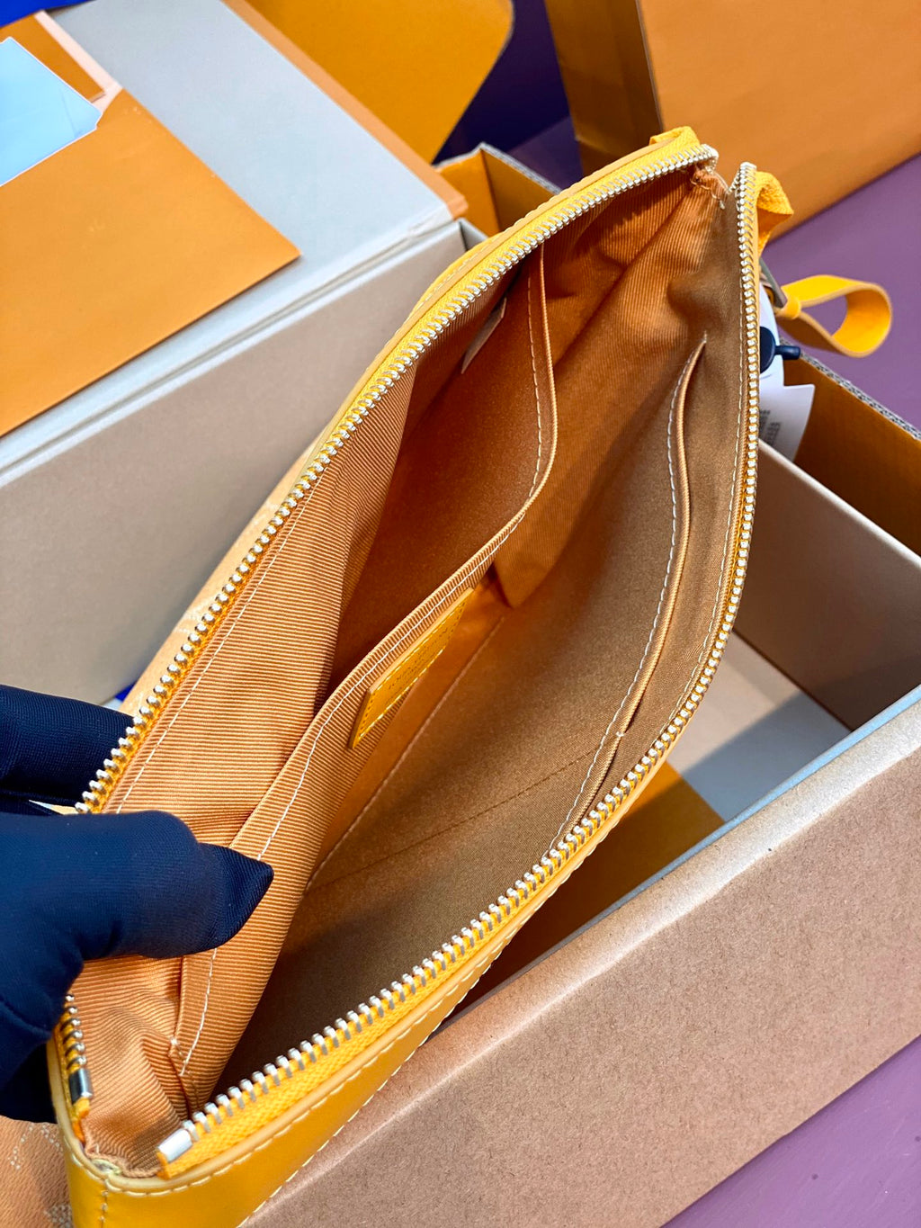 Yellow monogram bag interior view with open zip and tan lining
