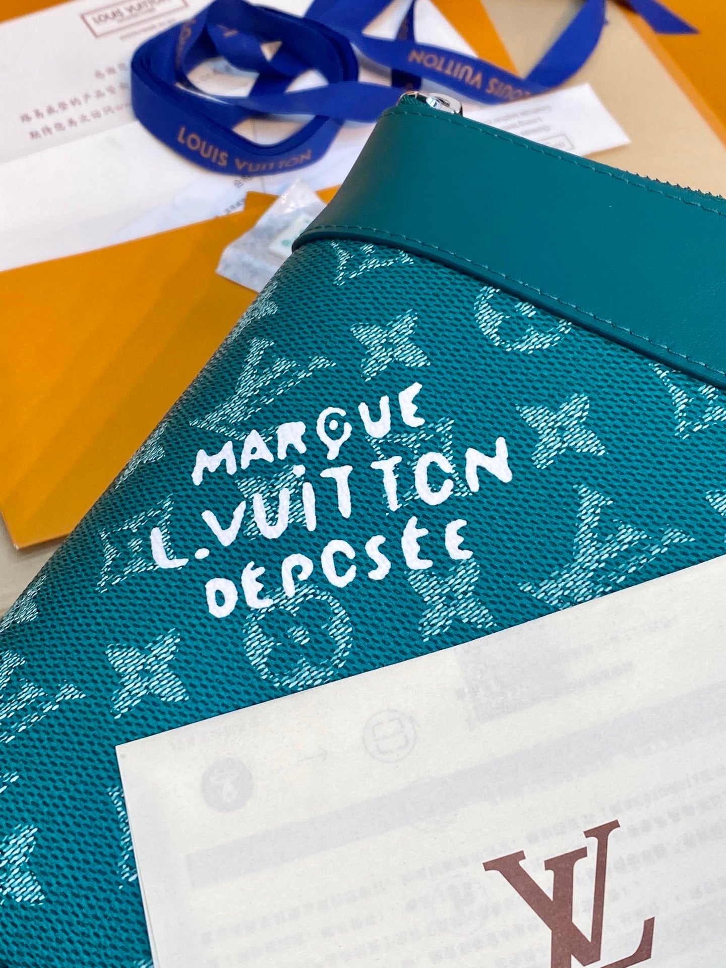 Teal Louis Vuitton monogram bag panel with white “MARY QUANT” lettering