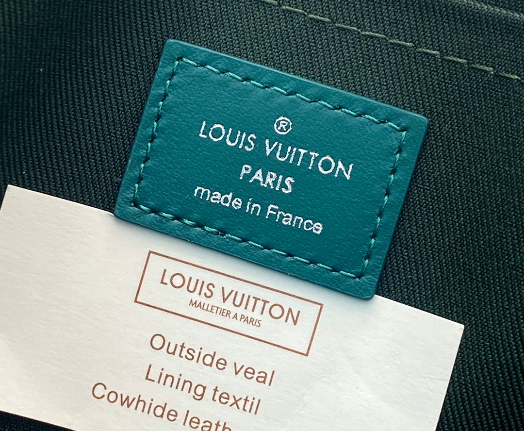 Teal Louis Vuitton leather label reading “LOUIS VUITTON PARIS” and “made in France”