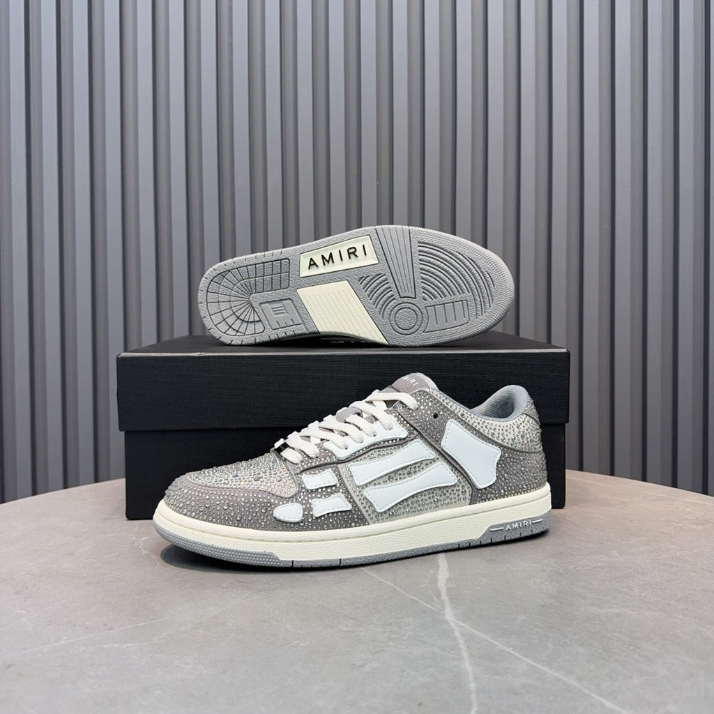 Low-top sneaker outsole view on box: silver and white upper with textured rubber tread