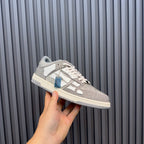 Low-top sneaker with silver speckled finish, white leather overlays, and lace-up front