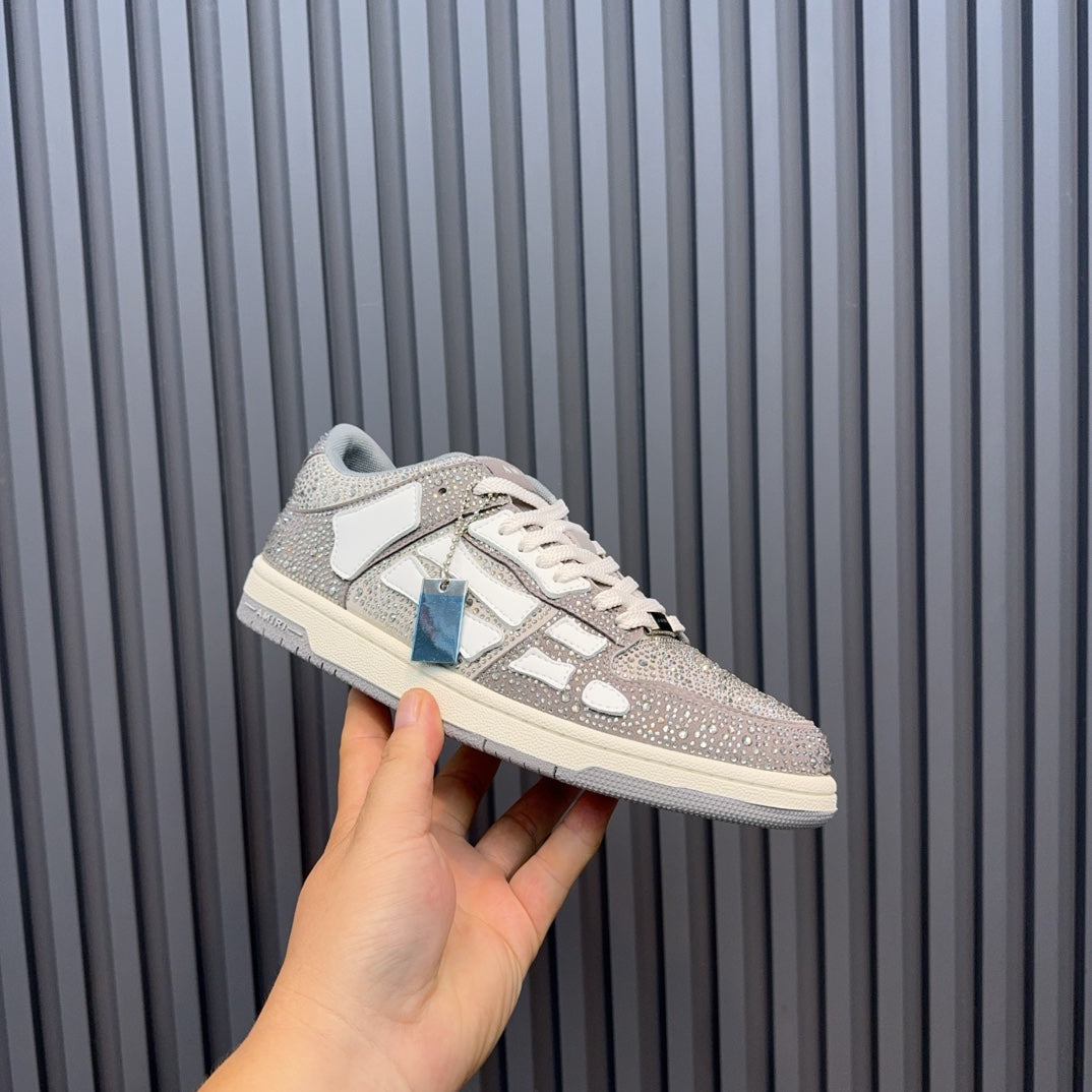 Low-top sneaker with silver speckled finish, white leather overlays, and lace-up front