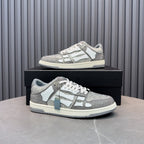 Low-top sneaker on box with silver speckled upper, white logo panel, and lace-up design