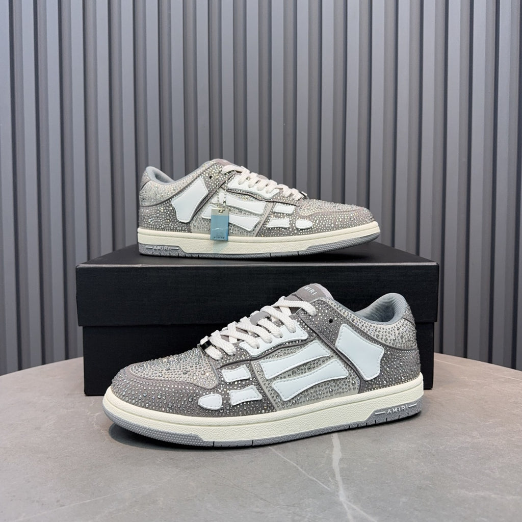 Low-top sneaker with silver speckled texture, white overlays, and light-blue accessory tag