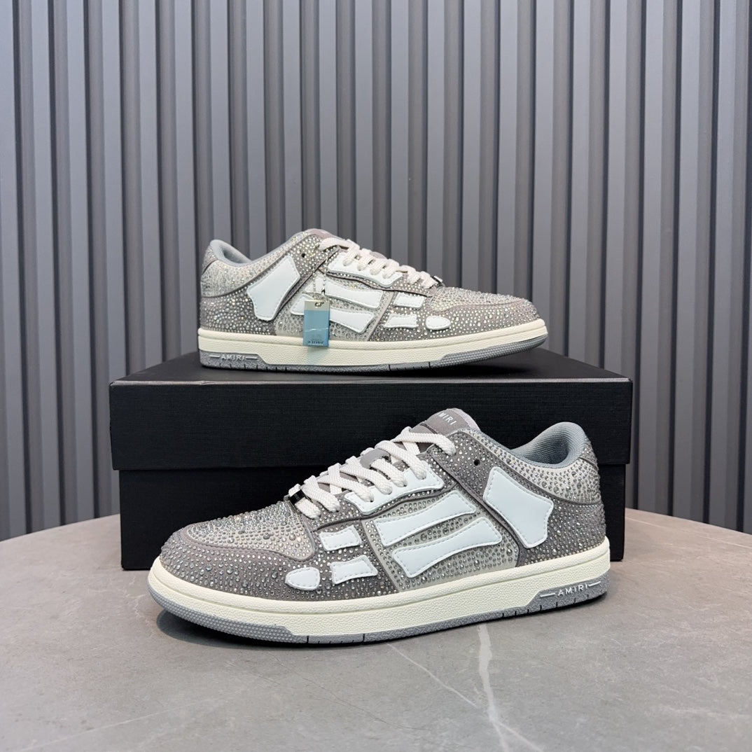 Low-top sneaker with silver speckled texture, white overlays, and light-blue accessory tag