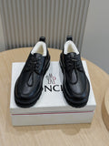 Black lace-up leather shoes with chunky rubber sole, padded collar, front laces.
