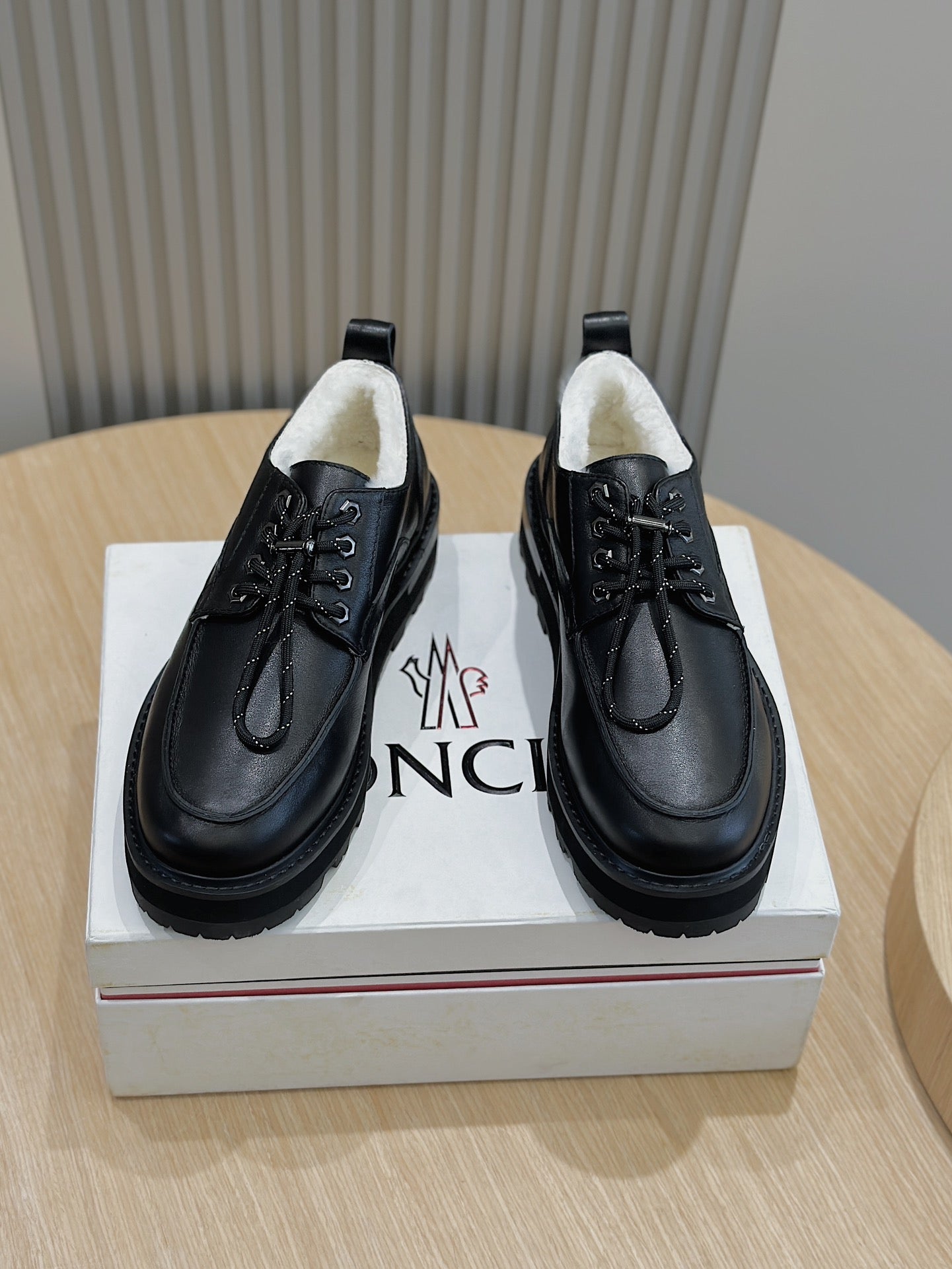 Black lace-up leather shoes with chunky rubber sole, padded collar, front laces.