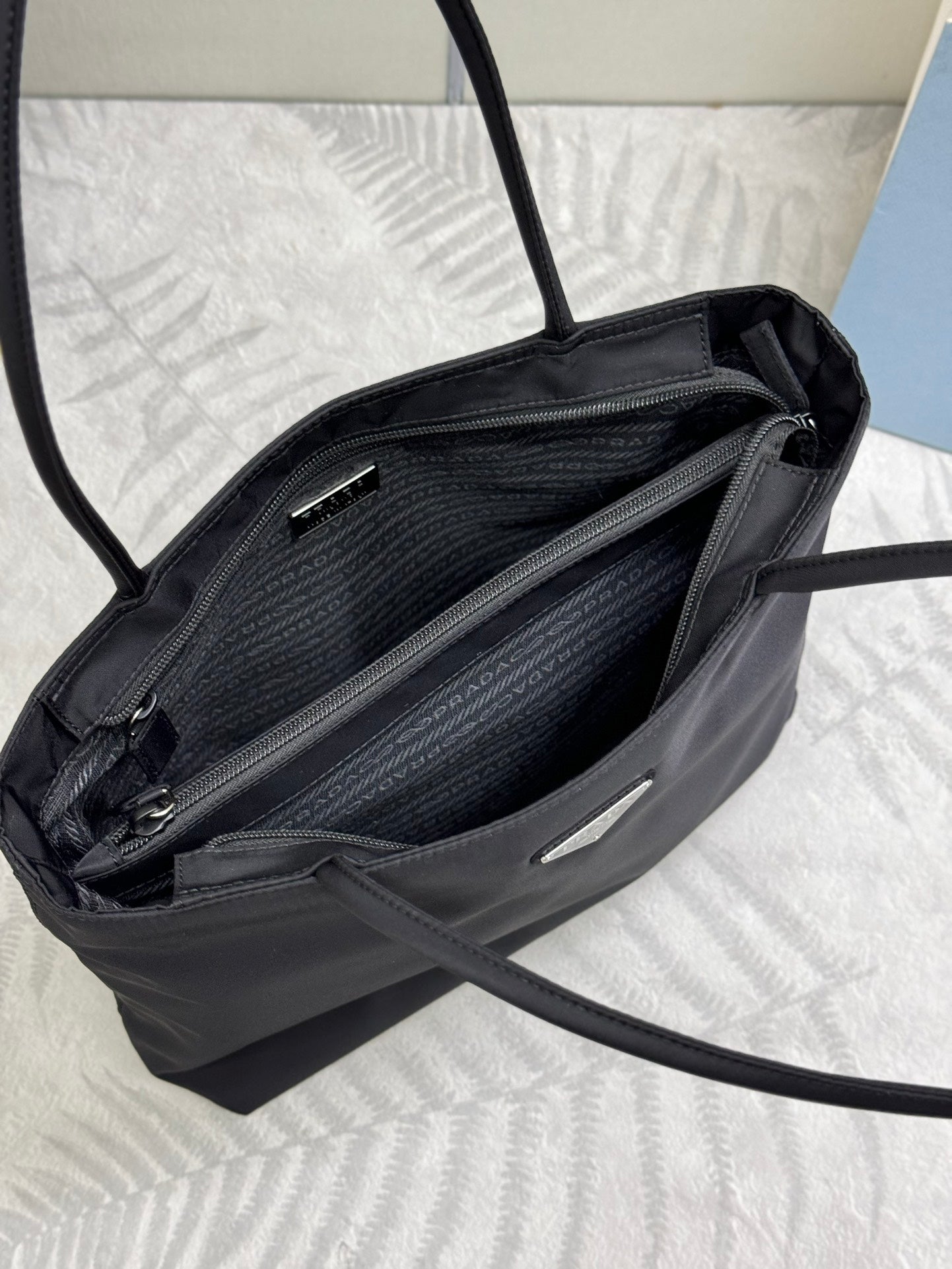 Prada tote bag open view with zippered inner pocket and fabric lining