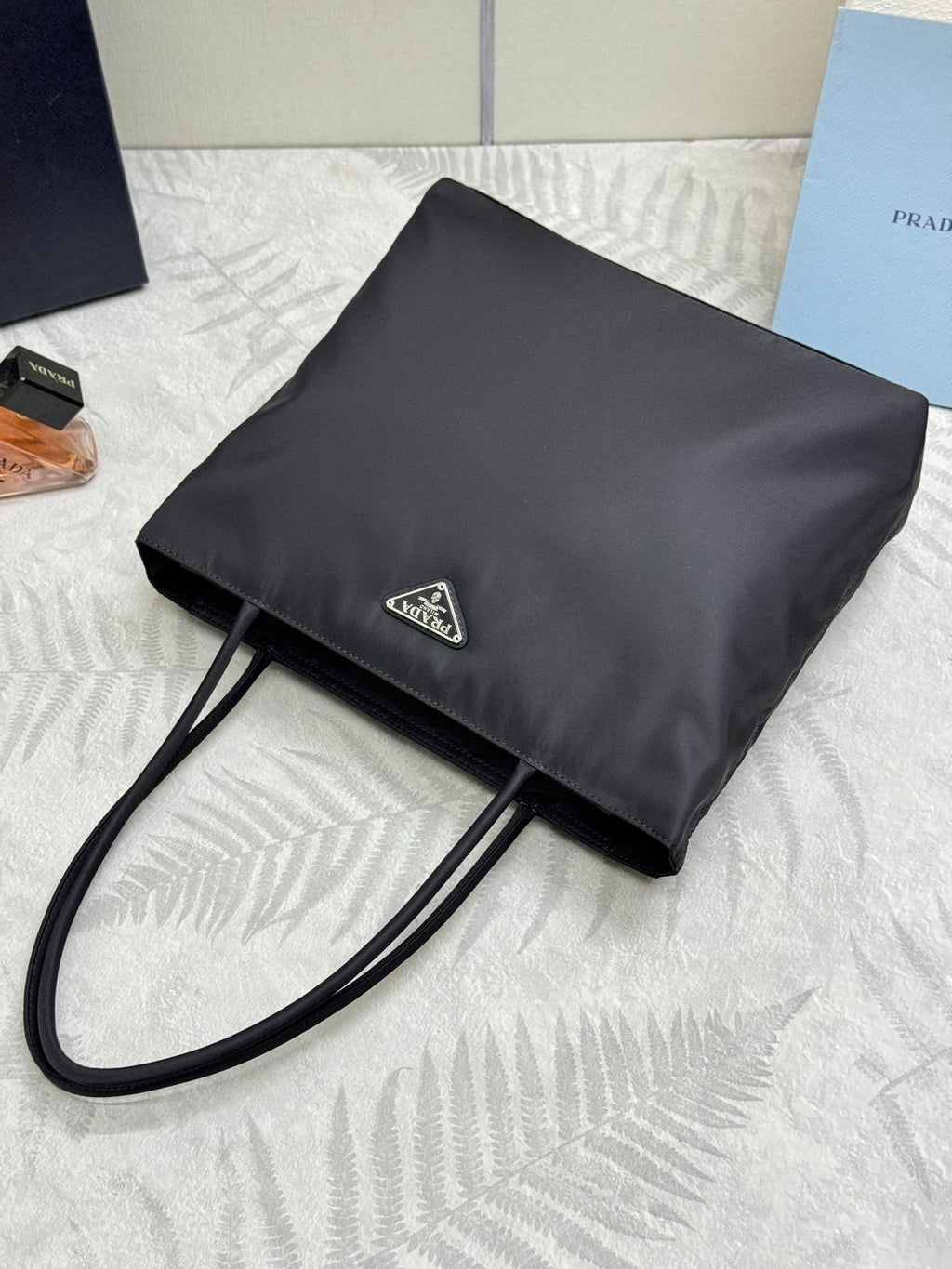 Black Prada shoulder bag with flap, adjustable strap, and triangle logo patch