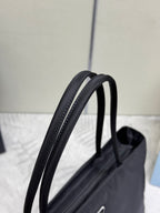 Prada tote bag with black leather top handles and contrast stitching