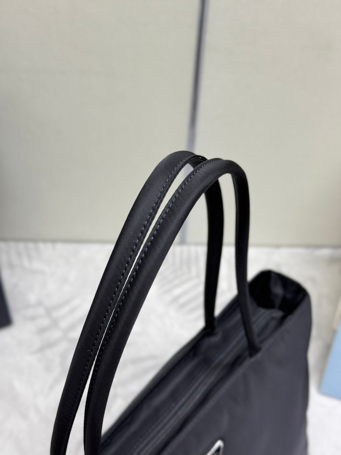 Prada tote bag with black leather top handles and contrast stitching