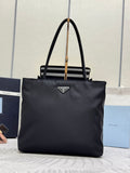 Prada tote bag with top handles, front triangle logo patch, magnetic closure