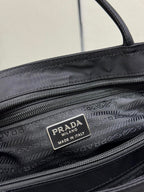 Prada interior label on black tote bag with zip pocket lining