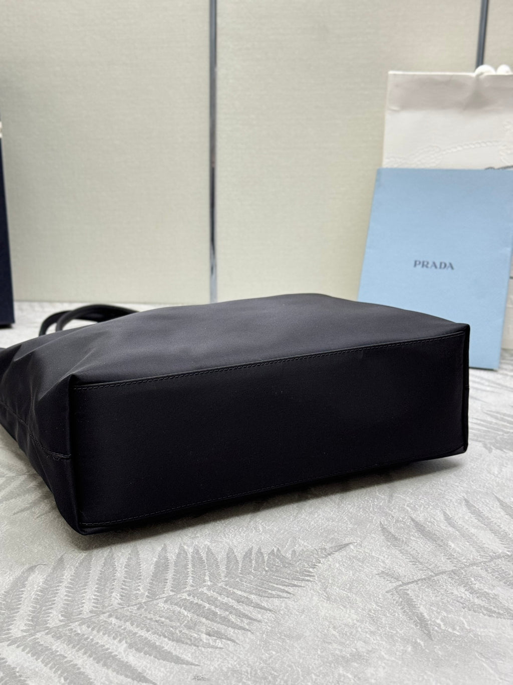 Prada tote bag with structured rectangular base and wide top handles