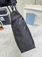 Prada long tote accessory in dark fabric with stitched seam detailing